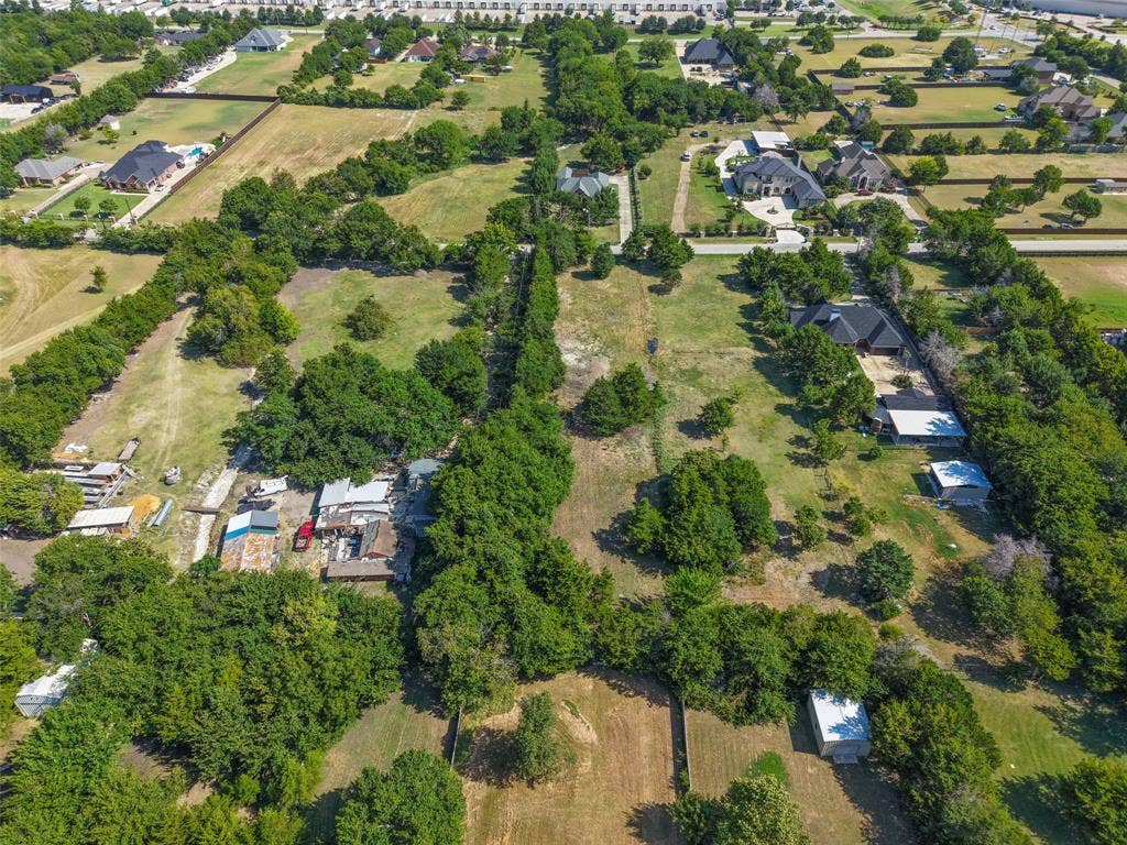 12 Winston Drive, DeSoto, TX 75115 Expansive property featuring a mix of cleared land and mature trees