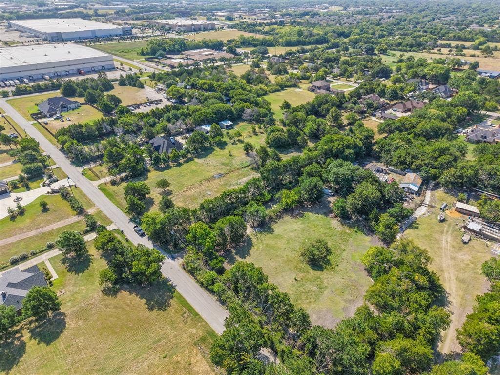 12 Winston Drive, DeSoto, TX 75115 Expansive rural landscape featuring a paved road, scattered residential properties, mature trees, and open grassy areas