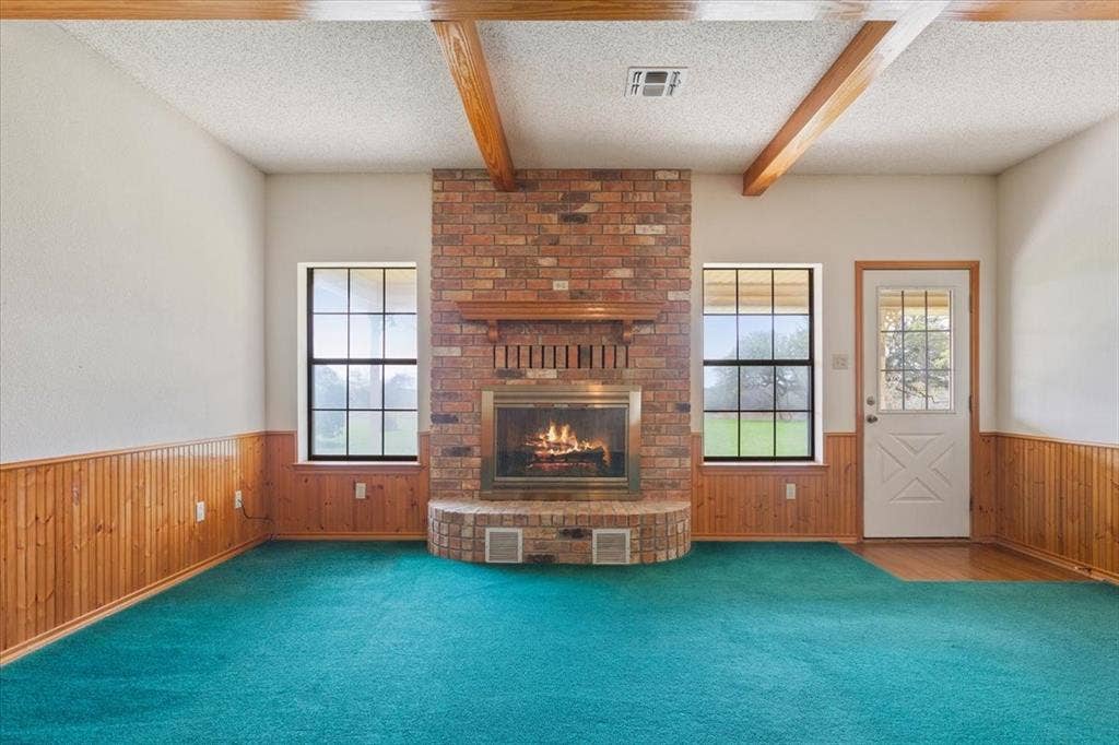 146 Indian Paint Brush Road, Eddy, TX 76524 Brick fireplace with a wood mantle, flanked by two grid-pane windows