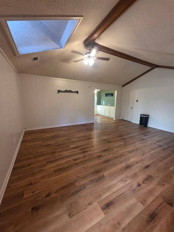 Den with skylight looking toward built ins in breakfast