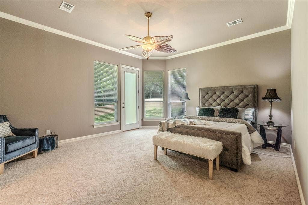 6420 Shady Oaks Lane, Midlothian, TX 76065 Huge primary bedroom with space for a sitting area, crown molding, natural light and an exterior door leading out onto a patio.