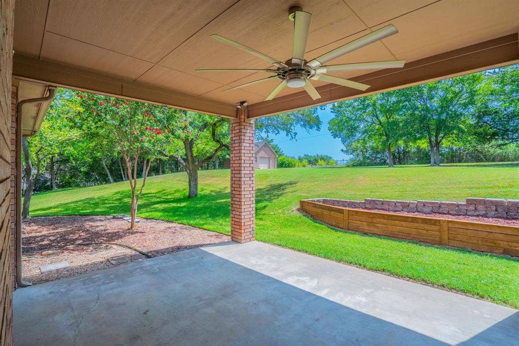 6420 Shady Oaks Lane, Midlothian, TX 76065 Covered outdoor patio facing the back yard with mature trees. The workshop is towards the back.