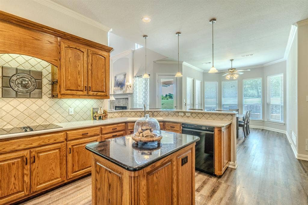 6420 Shady Oaks Lane, Midlothian, TX 76065 Kitchen island, tons of cooking and prep space with beautiful cabinetry facing the breakfast area with natural lighting.