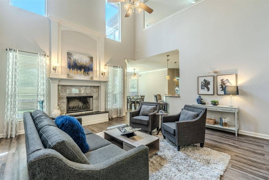 6420 Shady Oaks Lane, Midlothian, TX 76065 Huge living area with woodburning fireplace, cathedral ceilings, LVP flooring and tons of natural light.