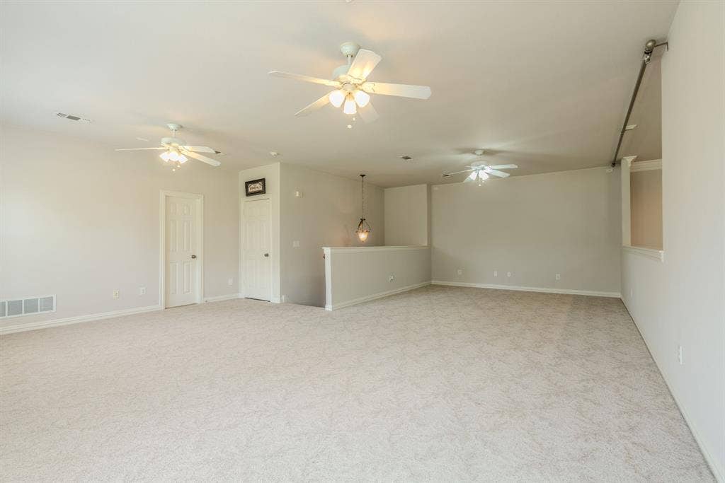 6420 Shady Oaks Lane, Midlothian, TX 76065 Upstairs game room area next to the loft area featuring ceiling fans, and tons of space for a pool table and hanging out!
