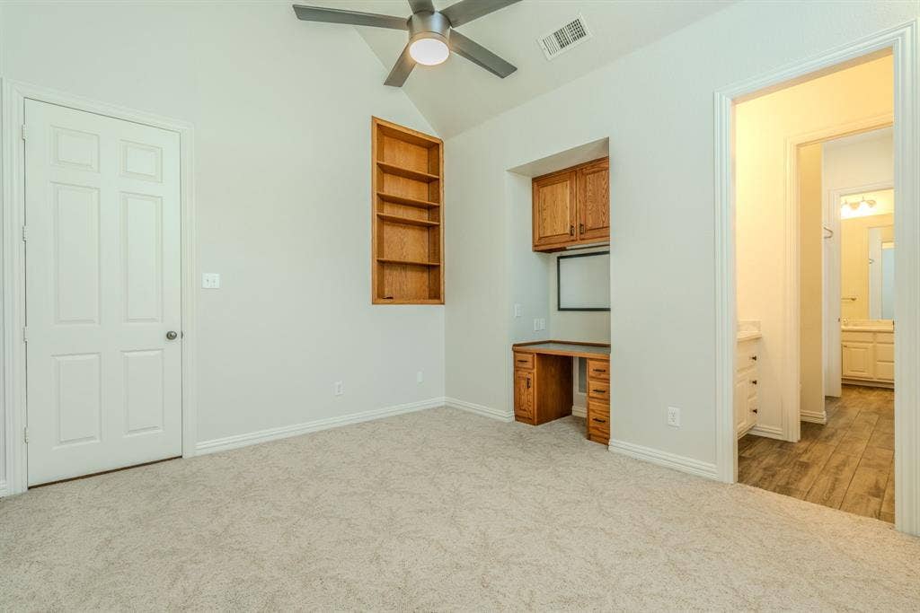 6420 Shady Oaks Lane, Midlothian, TX 76065 Another view of Bedroom 2 with built-in desk, cabinetry, and an ensuite bathroom.