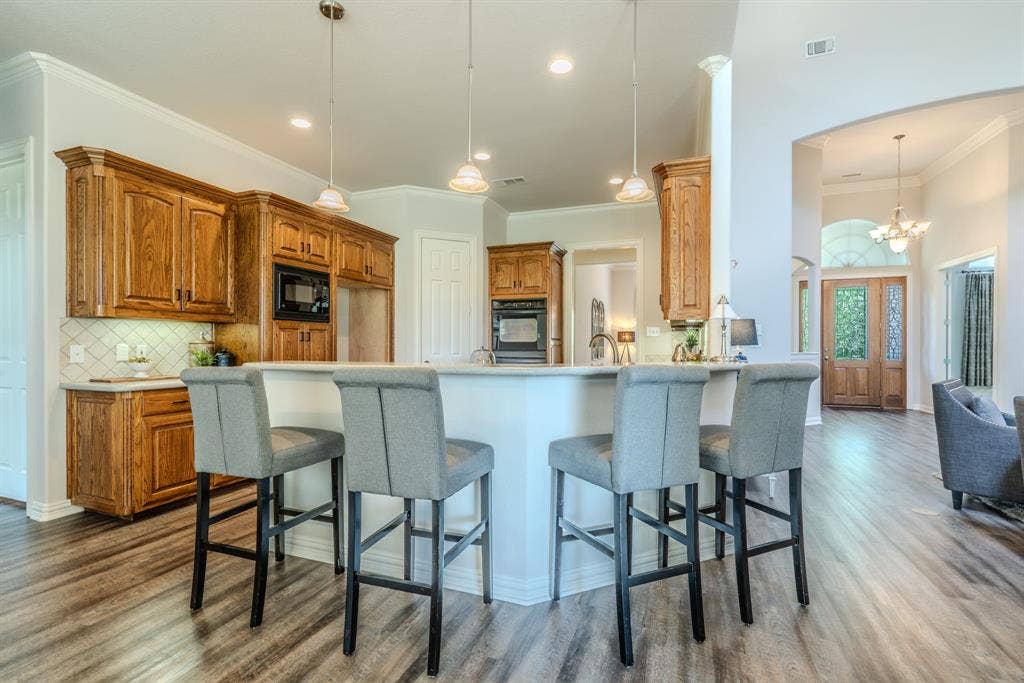 6420 Shady Oaks Lane, Midlothian, TX 76065 Spacious kitchen with breakfast bar, gorgeous cabinetry, and decorative lighting.