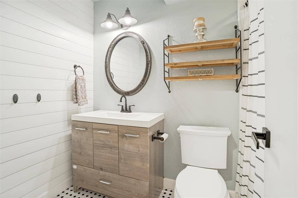 8201 Christie Drive, Frisco, TX 75033 Bathroom vanity with a white countertop and wood-finish cabinetry