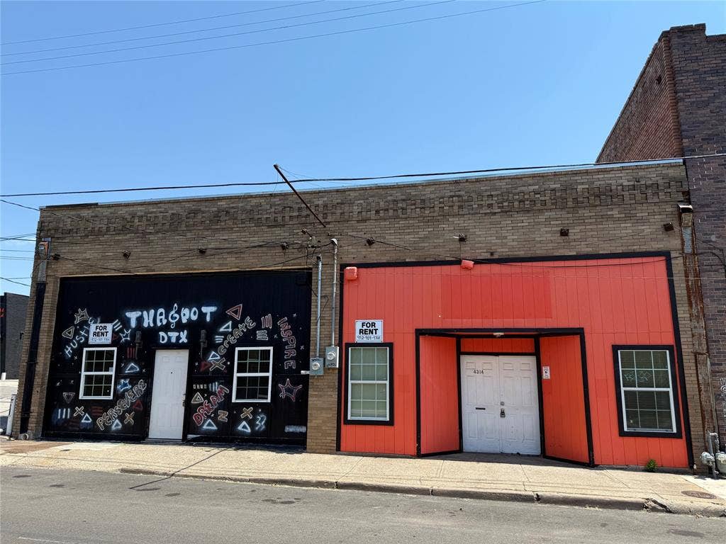 4314 Elm Street, Dallas, TX 75226 Commercial building featuring a brick facade with a black storefront section and an orange storefront section