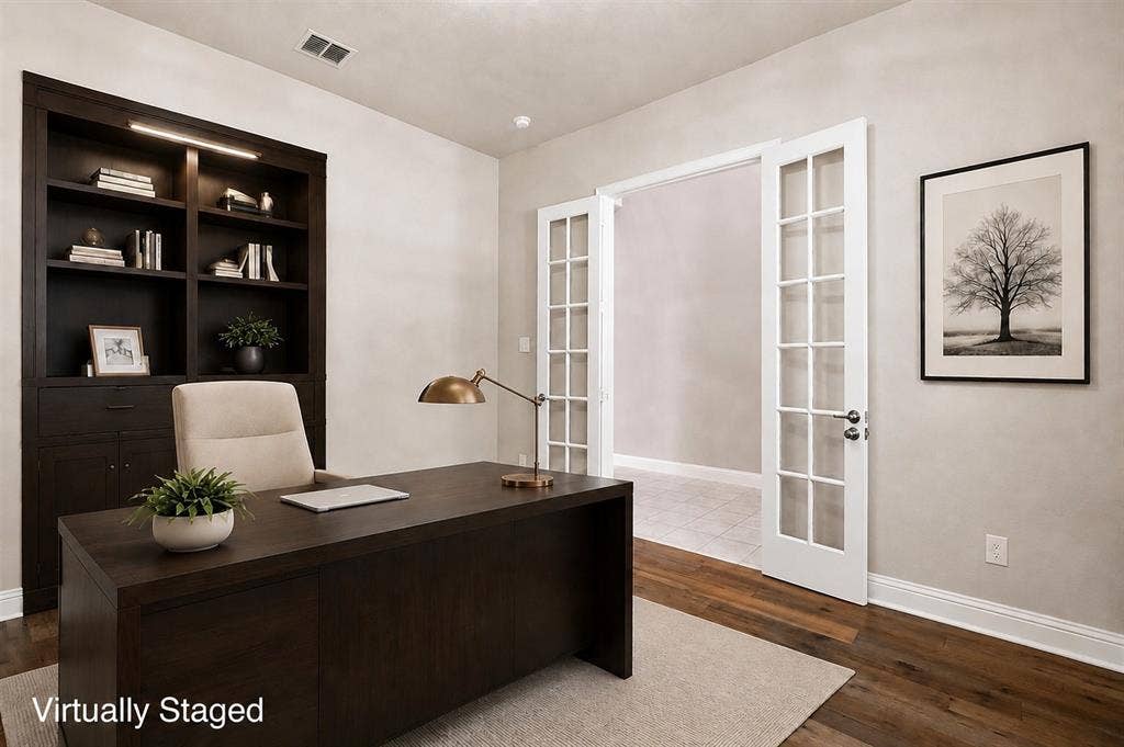 4109 Rainey Street, McKinney, TX 75070 Built-in dark wood cabinetry with integrated lighting, wood-finish flooring, and double French doors with glass panes
