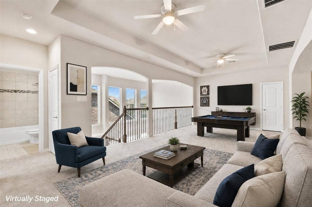4109 Rainey Street, McKinney, TX 75070 Carpeted open area with ceiling fans, a tray ceiling, and a built-in wall unit