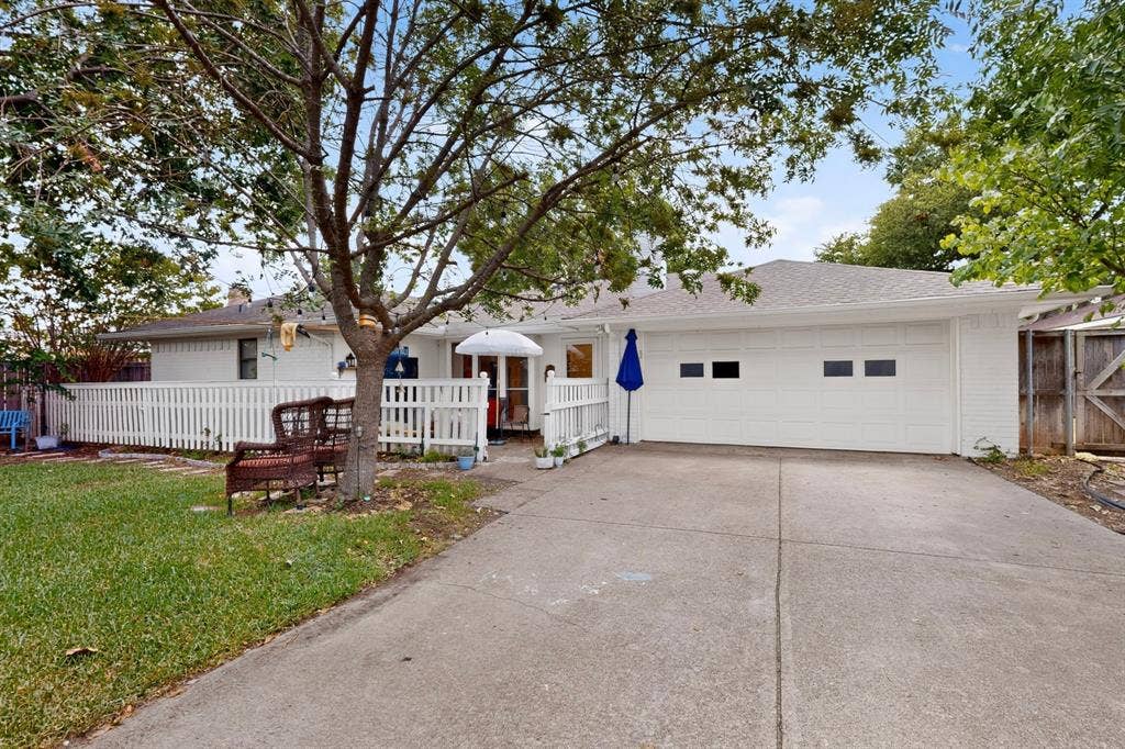 2003 J J Pearce Drive, Richardson, TX 75081 White picket fence enclosing a paved patio and Dog run area
