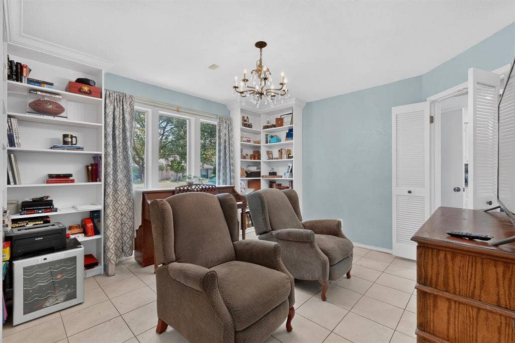 2003 J J Pearce Drive, Richardson, TX 75081 Room featuring white built-in shelving, tile flooring, and a chandelier light fixture