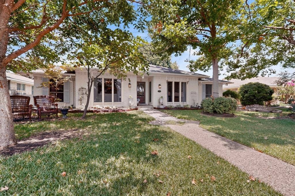 2003 J J Pearce Drive, Richardson, TX 75081 White brick exterior featuring large bay windows