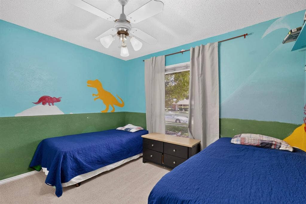 2003 J J Pearce Drive, Richardson, TX 75081 Room featuring a ceiling fan with integrated lighting, a window with natural light, and neutral carpeting