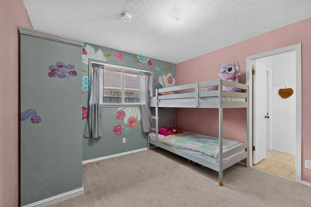 2003 J J Pearce Drive, Richardson, TX 75081 Bedroom with light-colored carpeting and a flush-mount ceiling light