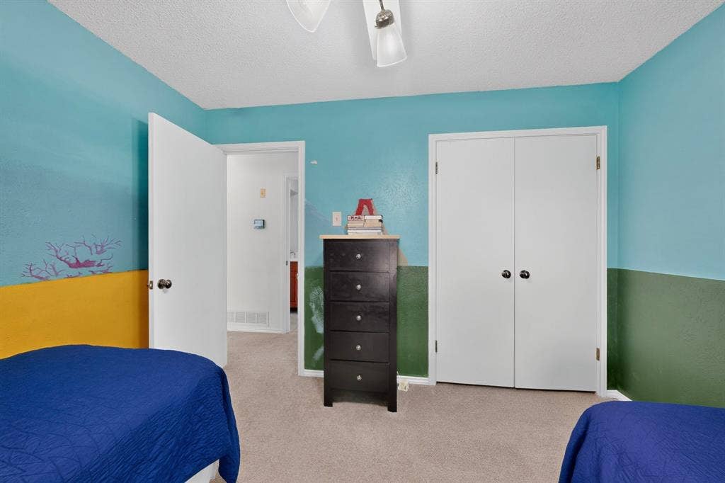 2003 J J Pearce Drive, Richardson, TX 75081 Carpeted room featuring a ceiling fan with integrated lighting, a double-door closet, and a white interior door