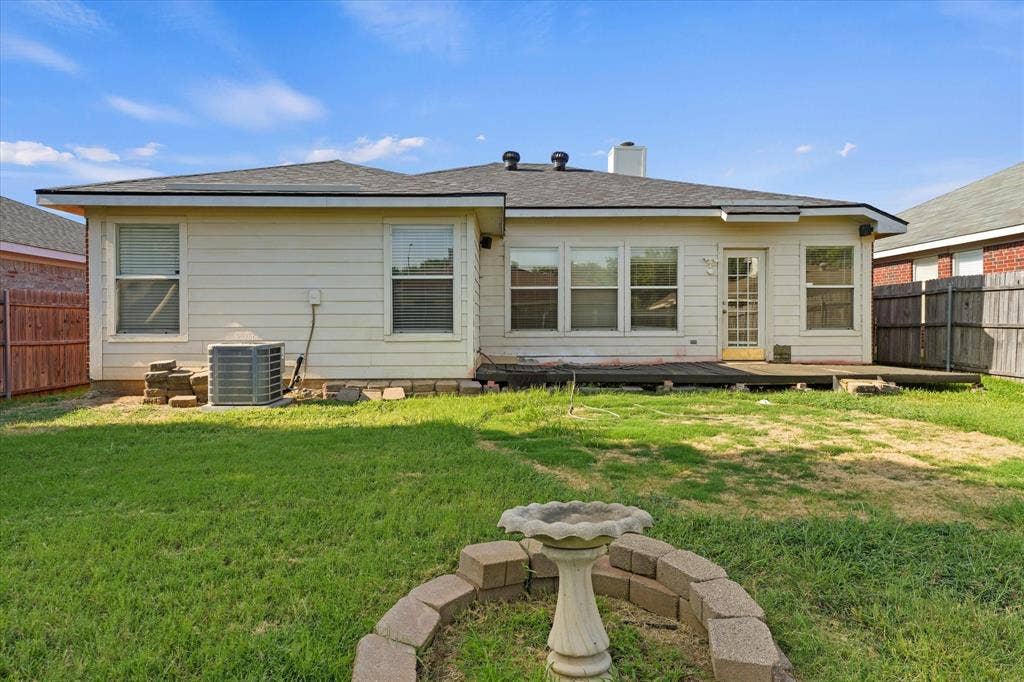 2312 Corral Drive, Fort Worth, TX 76133 Rear exterior featuring a wood deck, multiple windows, and a fenced perimeter