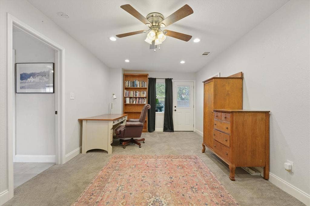 1112 Woodmount Court, Denton, TX 76209 Additional view of the spacious flex room featuring ample space for multiple uses, backyard access, recessed lighting, and room for a home office or guest accommodations.