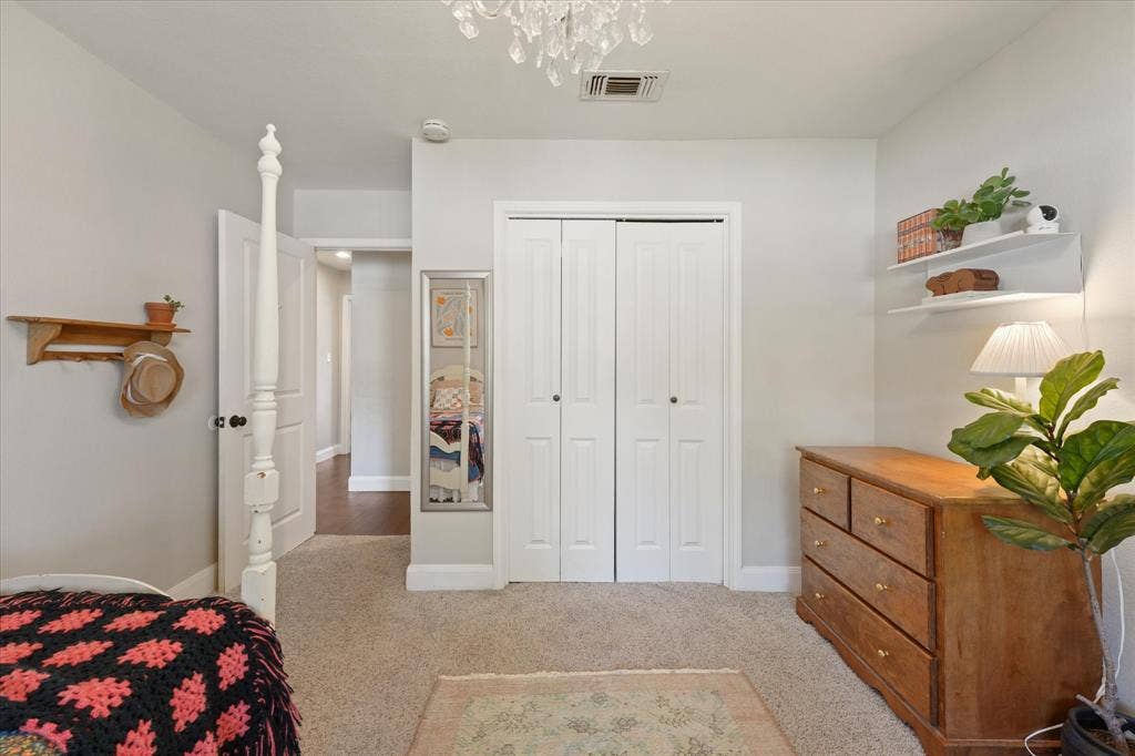 1112 Woodmount Court, Denton, TX 76209 Bright secondary bedroom with spacious closet, neutral finishes, and comfortable layout overlooking the front yard.