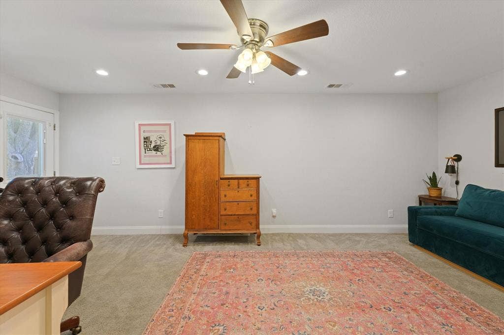 1112 Woodmount Court, Denton, TX 76209 Oversized flex room ideal for a home office, media room, playroom, guest suite, or second living area with recessed lighting and private exterior access.