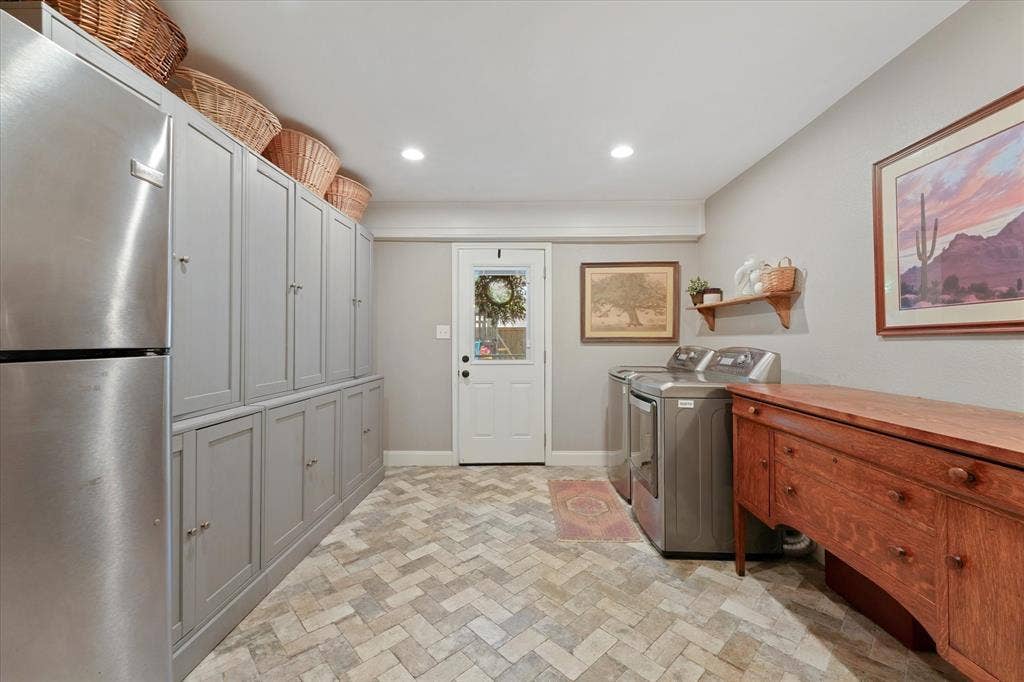 1112 Woodmount Court, Denton, TX 76209 Spacious utility room with abundant custom storage cabinets, room for a second refrigerator, full-size washer and dryer area, and direct access to the backyard.