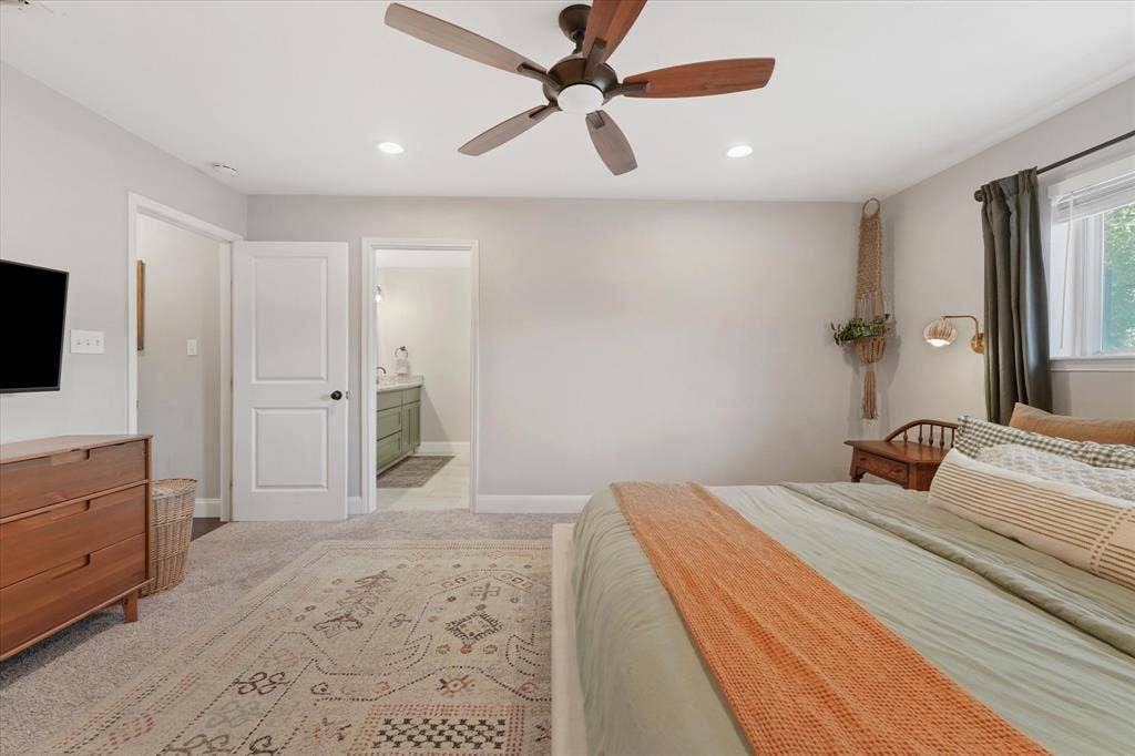 1112 Woodmount Court, Denton, TX 76209 Additional view of the oversized primary suite featuring an ensuite bathroom, neutral finishes, and generous wall space for flexible furniture placement.