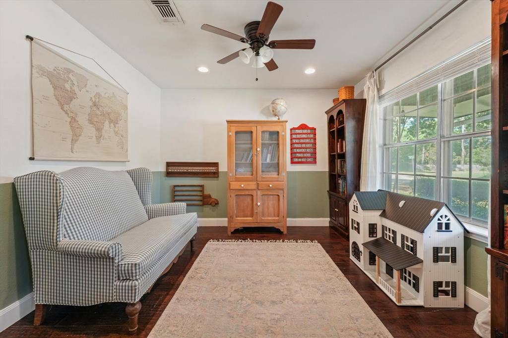 1112 Woodmount Court, Denton, TX 76209 Oversized flex room with hardwood floors, large front-facing windows, and barn doors, ideal for a home office, playroom, library, or second living area.