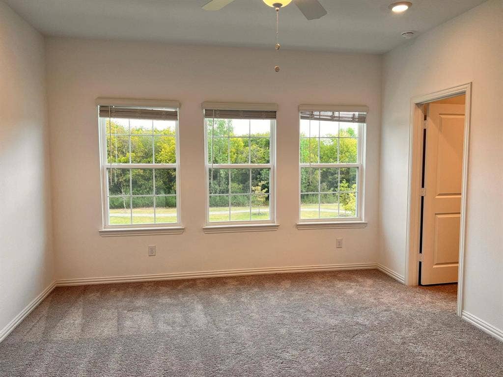 1054 Old Rosebud Drive, Allen, TX 75013 Bright room featuring three double-hung windows, recessed ceiling lighting, a ceiling fan, plush carpet flooring, and white trim