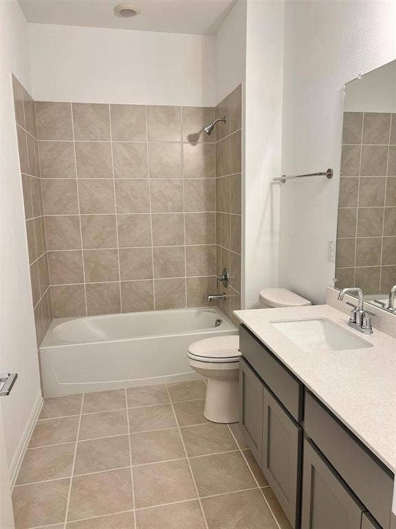 1054 Old Rosebud Drive, Allen, TX 75013 Bathroom featuring a full-size tub with tile surround, a built-in vanity with light-toned countertop and undermount sink, and tiled flooring