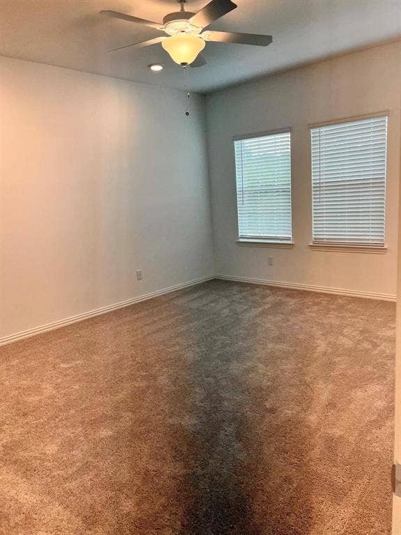 1054 Old Rosebud Drive, Allen, TX 75013 Spacious room featuring neutral carpeting, a ceiling fan with integrated lighting, recessed lighting, and two windows with blinds