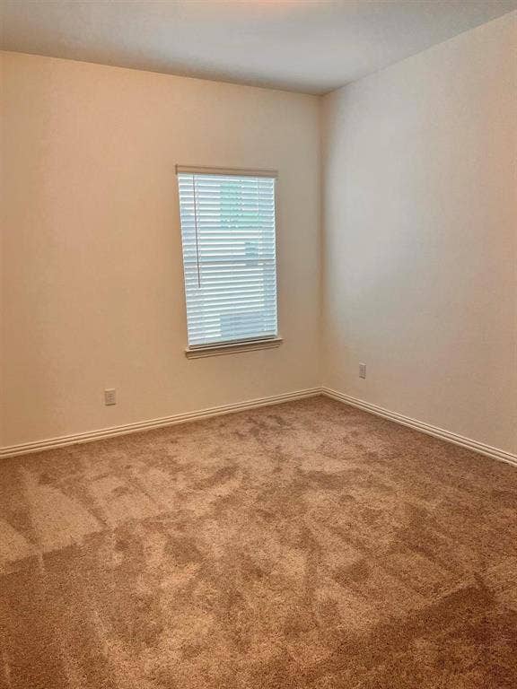 1054 Old Rosebud Drive, Allen, TX 75013 Room featuring neutral-toned walls, a single window with horizontal blinds, and tan carpet flooring