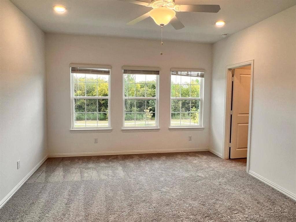 1054 Old Rosebud Drive, Allen, TX 75013 Carpeted room featuring three windows with blinds, recessed lighting, and a ceiling fan with integrated light fixture