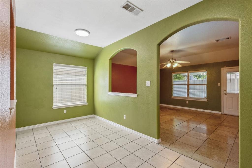 8614 Torreon Court, Dallas, TX 75217 Empty room with ceiling fan and light tile flooring