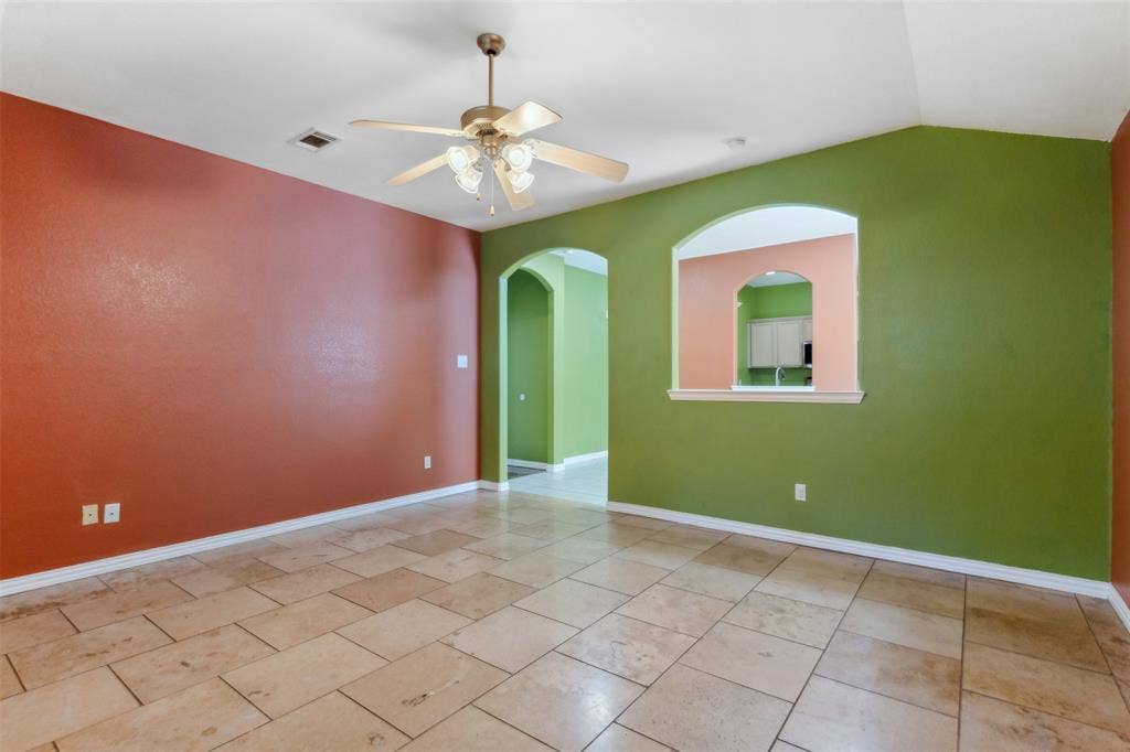 8614 Torreon Court, Dallas, TX 75217 Tiled empty room with lofted ceiling and ceiling fan