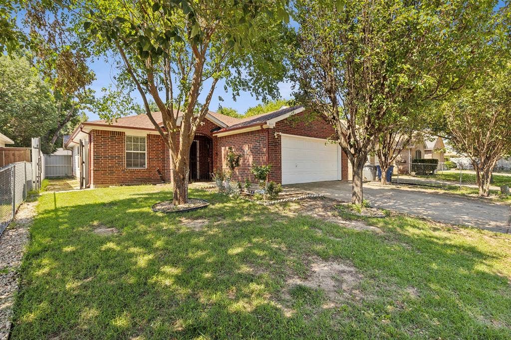 8614 Torreon Court, Dallas, TX 75217 Single story home with a garage and a front yard