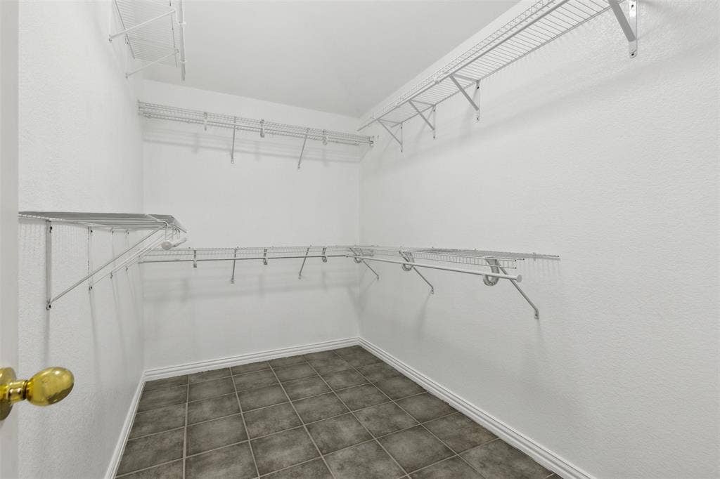 8614 Torreon Court, Dallas, TX 75217 Walk in closet with tile floors