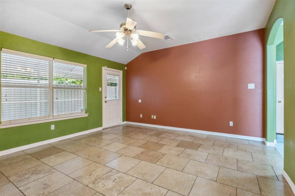 8614 Torreon Court, Dallas, TX 75217 Tiled spare room featuring lofted ceiling and ceiling fan