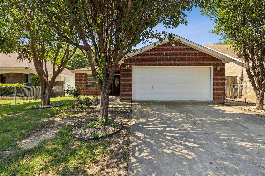 8614 Torreon Court, Dallas, TX 75217 Single story home with a garage and a front lawn