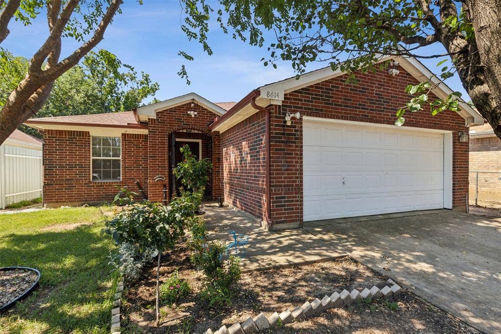 8614 Torreon Court, Dallas, TX 75217 Ranch-style house with a garage and a front lawn
