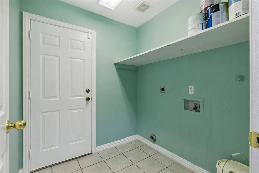 8614 Torreon Court, Dallas, TX 75217 Washroom featuring tile floors, hookup for an electric dryer, and washer hookup