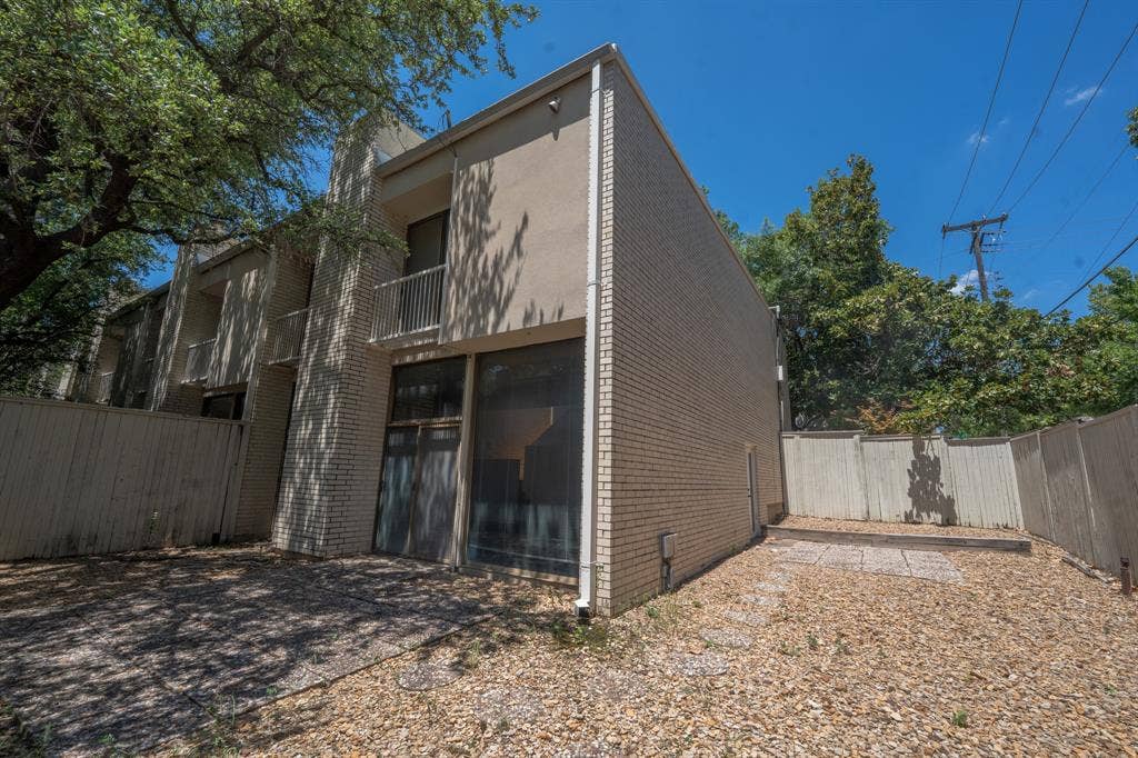2818 Welborn Drive, #9, Dallas, TX 75219 Multi-level building with a light brick facade and stucco accents