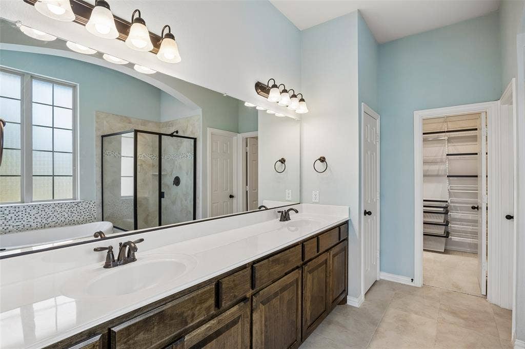 Double vanity with white countertops and dark wood cabinetry