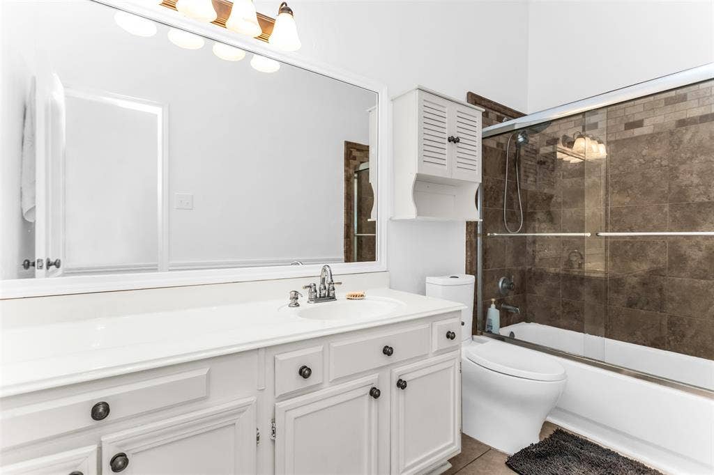 11404 Amber Valley Drive, Frisco, TX 75035 White vanity with ample counter space, integrated sink, and cabinet storage