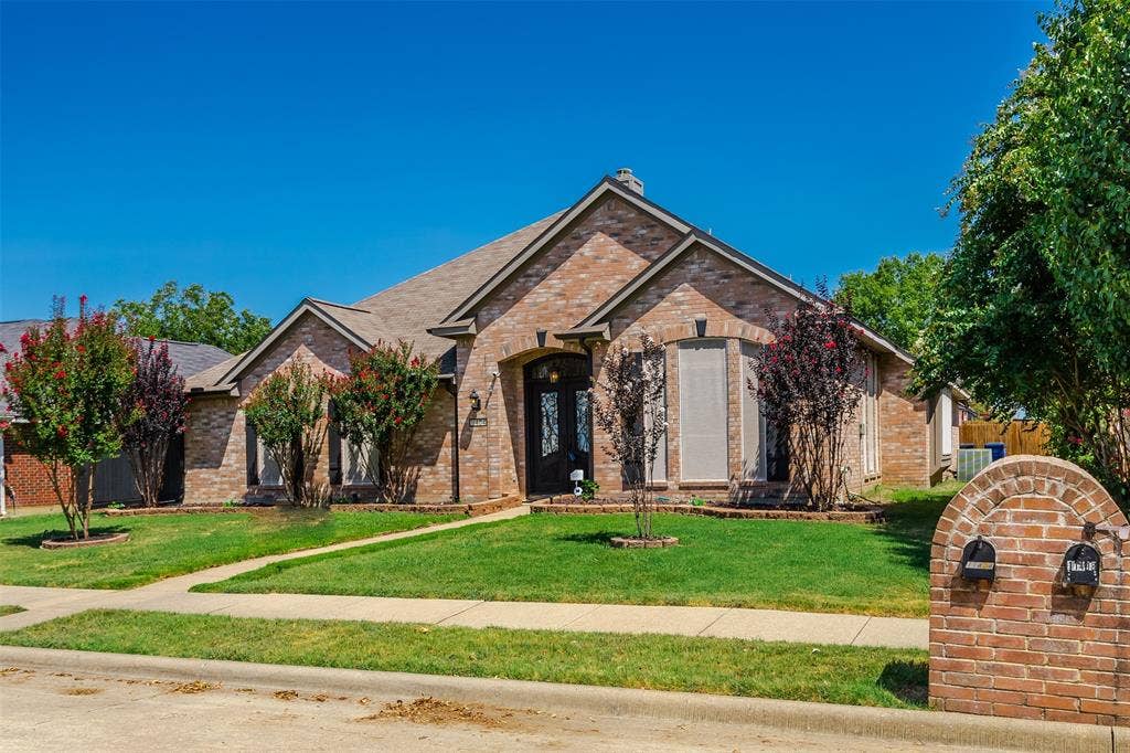 11404 Amber Valley Drive, Frisco, TX 75035 Brick exterior with arched entry, bay window, and gabled roofline