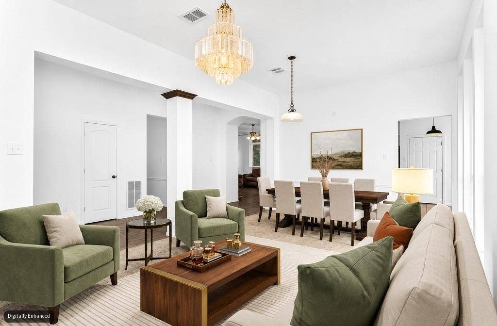 11404 Amber Valley Drive, Frisco, TX 75035 Spacious open-concept interior featuring light walls, a crystal chandelier, and a decorative column