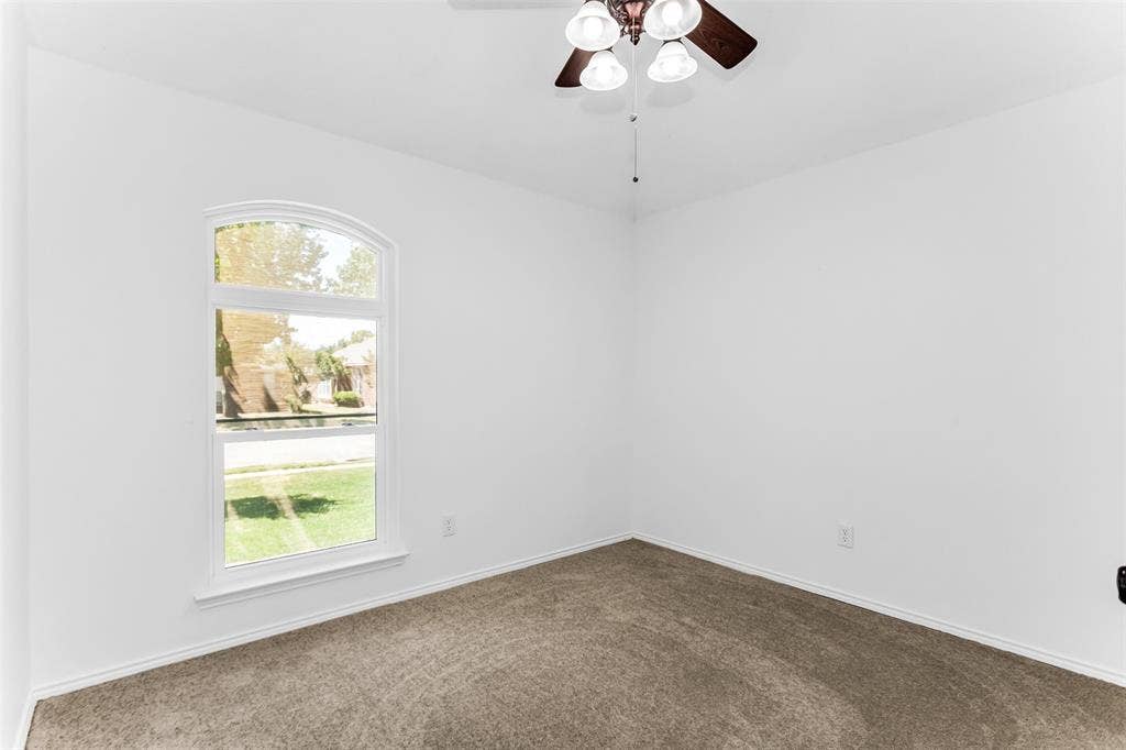 11404 Amber Valley Drive, Frisco, TX 75035 White painted walls, carpeted flooring, and an arched window