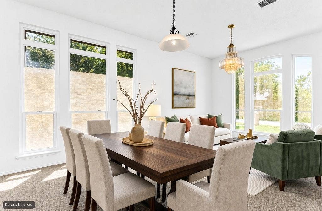 11404 Amber Valley Drive, Frisco, TX 75035 Bright dining area featuring a dark wood-finish table and a chandelier light fixture