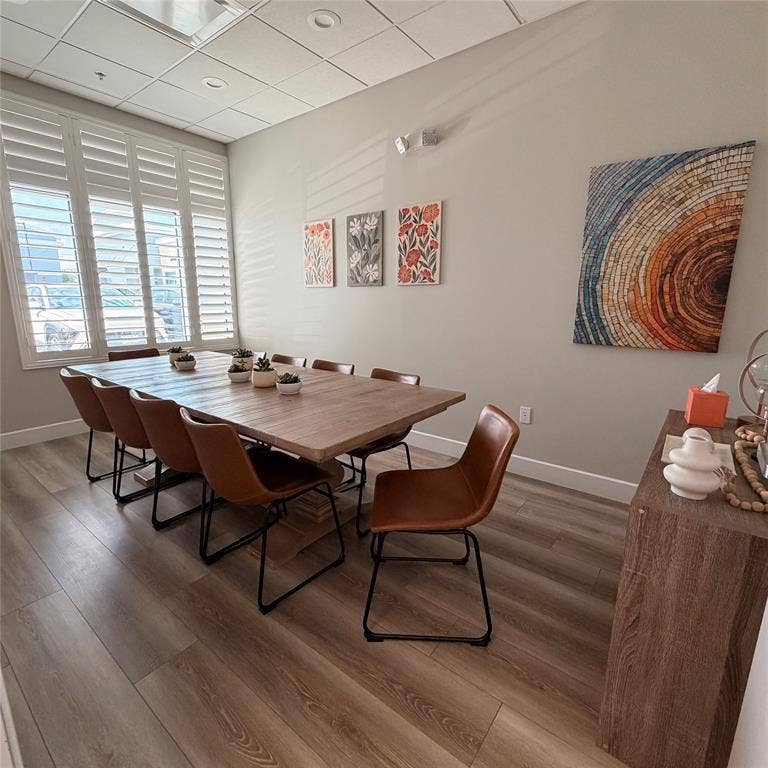 945 Stockton Drive, #7120, Allen, TX 75013 Spacious room featuring wood-finish flooring, plantation shutters, and a suspended ceiling with recessed lighting