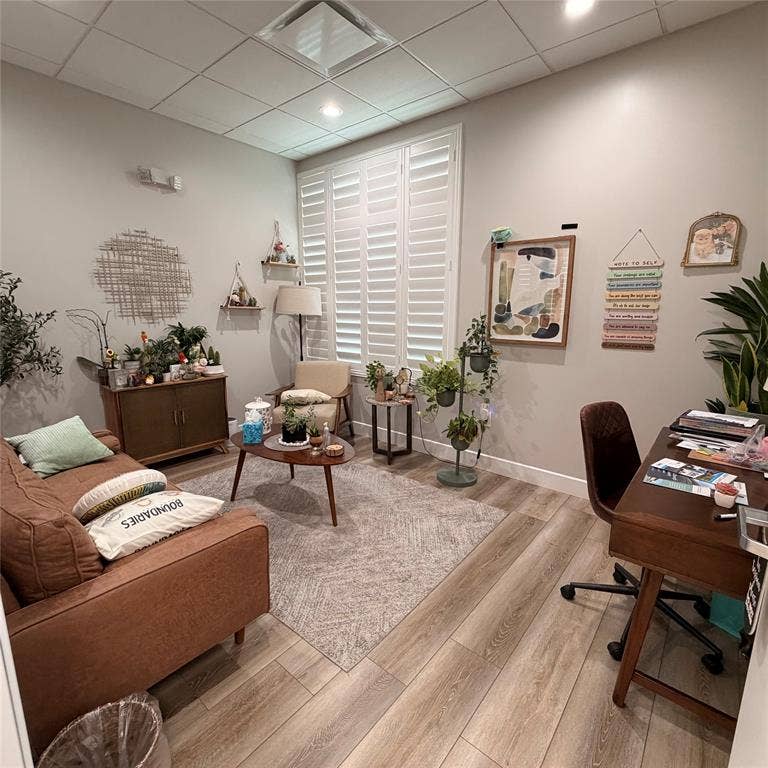 945 Stockton Drive, #7120, Allen, TX 75013 Well-appointed room featuring wood-finish flooring, white plantation shutters, recessed lighting, and a neutral wall palette